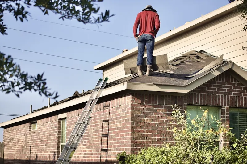 Professional roofer working on a residential roof in Rio Grande
